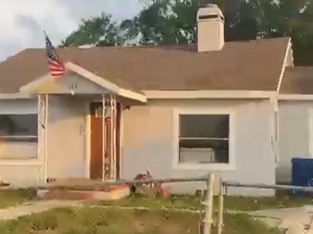 380 S Echo Dr, Lake Alfred, FL 33850 - view of front of property featuring a chimney and stucco siding