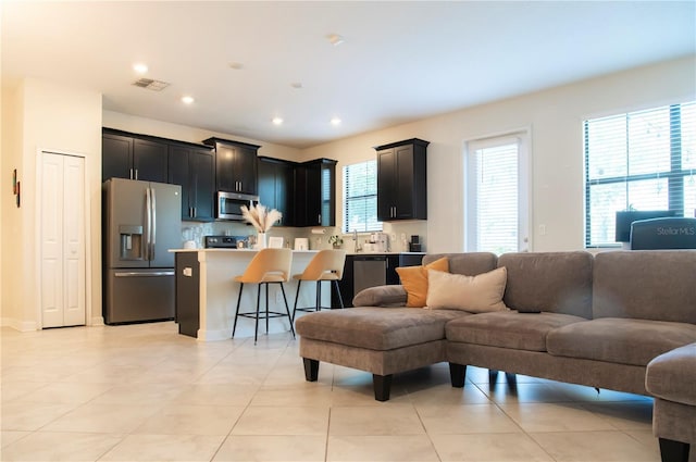 11378 Whistling Pine Way, Orlando, FL 32832 - living area with light tile patterned flooring and recessed lighting
