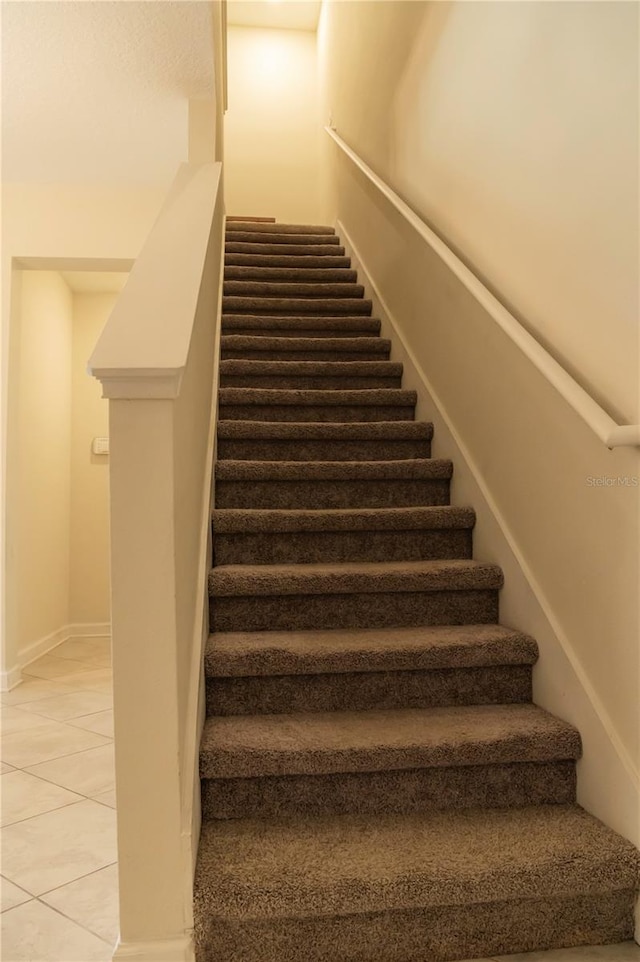 11378 Whistling Pine Way, Orlando, FL 32832 - staircase with tile patterned flooring and baseboards