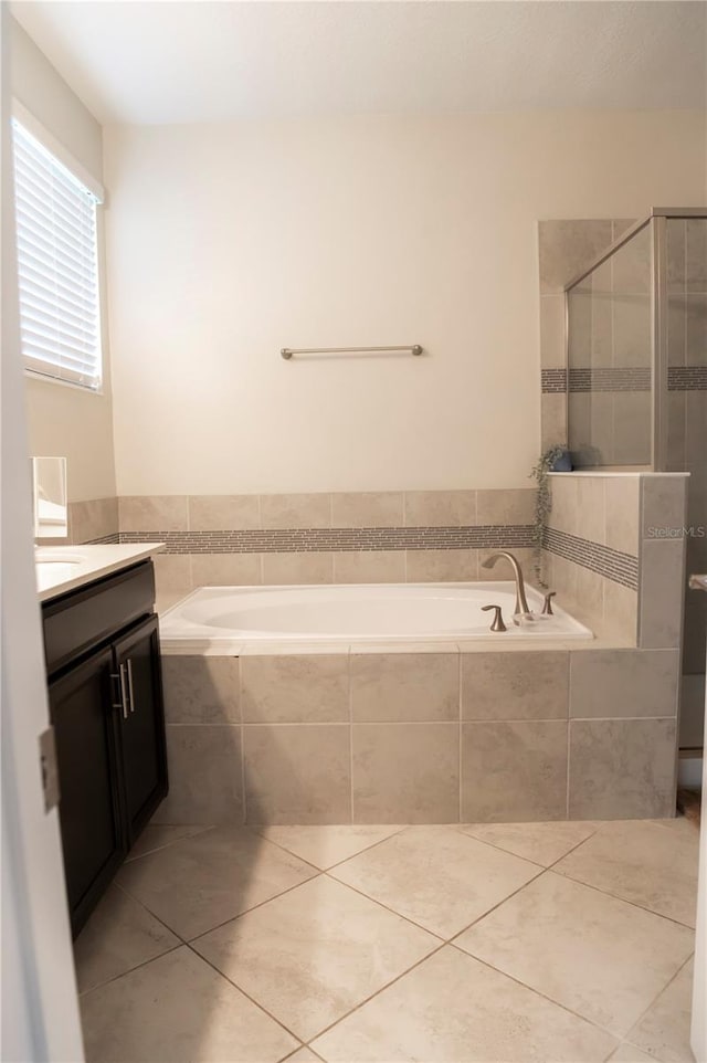 11378 Whistling Pine Way, Orlando, FL 32832 - full bathroom featuring a garden tub, vanity, a stall shower, and tile patterned floors