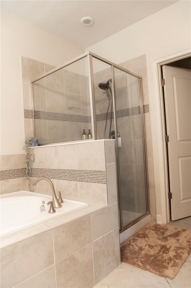 11378 Whistling Pine Way, Orlando, FL 32832 - bathroom featuring a stall shower, a garden tub, and tile patterned flooring