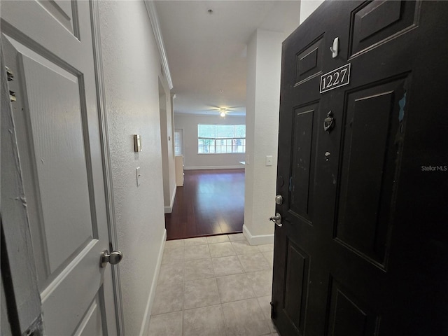 2572 Robert Trent Jones Dr Unit 1227, Orlando, FL 32835 - hallway with light tile patterned flooring and baseboards