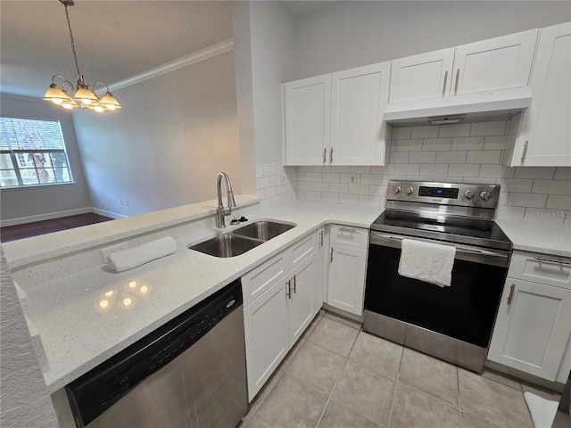 2572 Robert Trent Jones Dr Unit 1227, Orlando, FL 32835 - kitchen with appliances with stainless steel finishes, under cabinet range hood, a sink, ornamental molding, and a peninsula