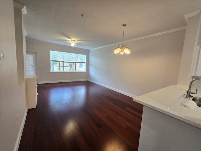2572 Robert Trent Jones Dr Unit 1227, Orlando, FL 32835 - unfurnished dining area with dark wood-type flooring, a sink, ceiling fan, crown molding, and baseboards