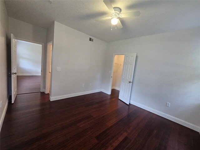 2572 Robert Trent Jones Dr Unit 1227, Orlando, FL 32835 - empty room with ceiling fan, dark wood-type flooring, and baseboards