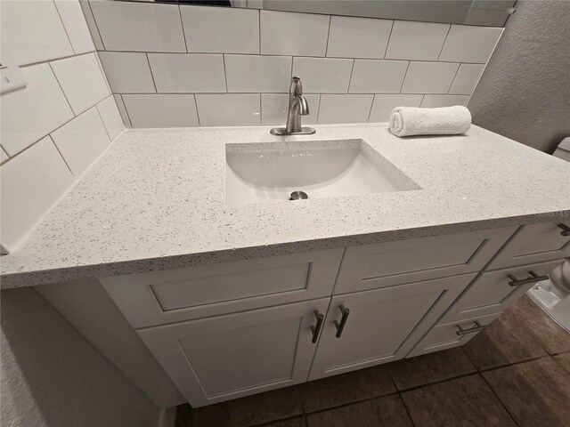 2572 Robert Trent Jones Dr Unit 1227, Orlando, FL 32835 - bathroom featuring vanity, tasteful backsplash, and tile patterned flooring