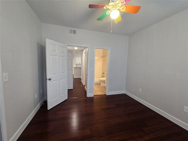 2572 Robert Trent Jones Dr Unit 1227, Orlando, FL 32835 - unfurnished bedroom featuring wood finished floors, baseboards, ensuite bath, and a ceiling fan