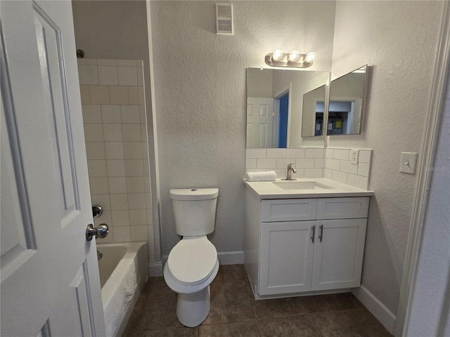 2572 Robert Trent Jones Dr Unit 1227, Orlando, FL 32835 - bathroom with vanity, toilet, a textured wall, tile patterned floors, and tub / shower combination