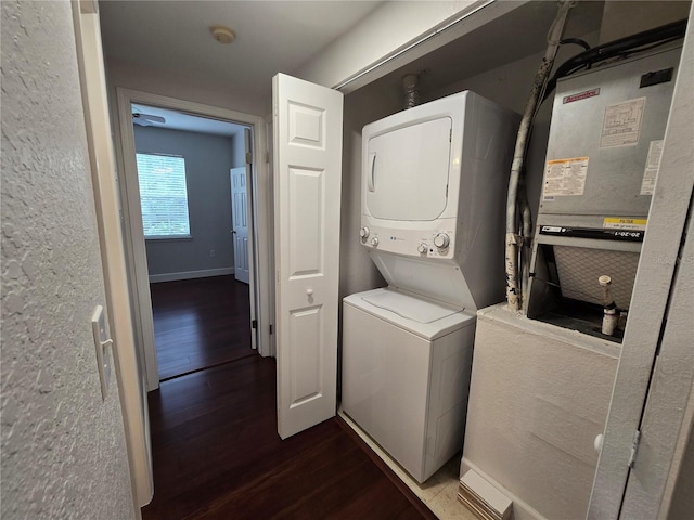 2572 Robert Trent Jones Dr Unit 1227, Orlando, FL 32835 - laundry room featuring stacked washing machine and dryer and dark wood-style floors