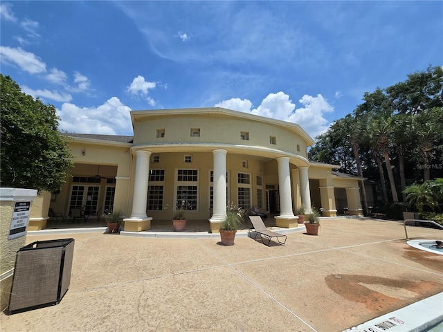 2572 Robert Trent Jones Dr Unit 1227, Orlando, FL 32835 - back of property featuring stucco siding and a patio area