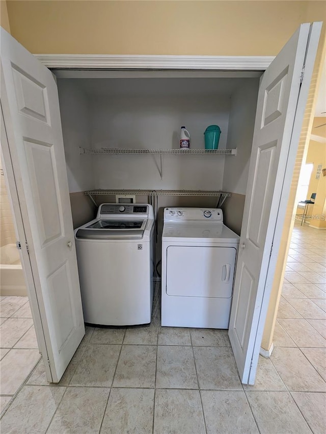 13940 Corrine Key Pl, Orlando, FL 32824 - laundry area with washer and dryer and light tile patterned floors