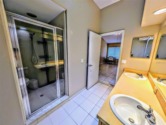 13940 Corrine Key Pl, Orlando, FL 32824 - full bathroom featuring double vanity, a stall shower, tile patterned floors, and toilet