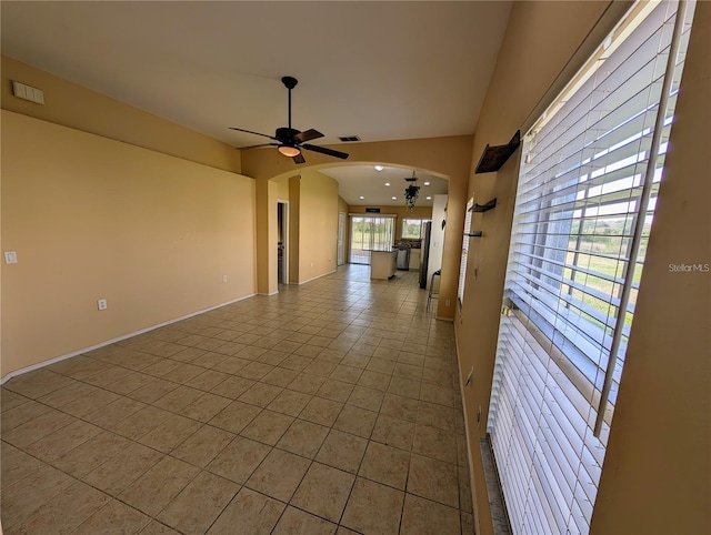 13940 Corrine Key Pl, Orlando, FL 32824 - tiled spare room with arched walkways, ceiling fan, and baseboards