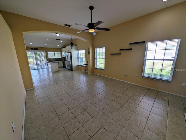13940 Corrine Key Pl, Orlando, FL 32824 - unfurnished living room featuring light tile patterned floors, arched walkways, ceiling fan, recessed lighting, and baseboards