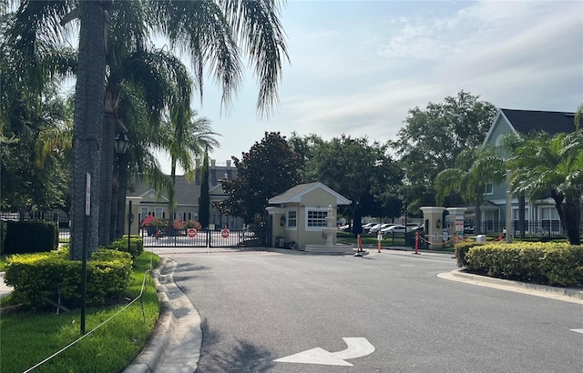 4008 San Gallo Dr Unit 106, Kissimmee, FL 34741 - view of asphalt road featuring curbs, a gated entry, and a gate