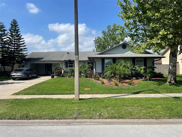 4926 Reginald Rd, Orlando, FL 32829 - ranch-style home featuring a garage, concrete driveway, and stucco siding