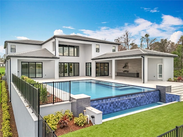 15121 Pendio Dr, Montverde, FL 34756 - rear view of property featuring stucco siding, a patio, and a pool with connected hot tub