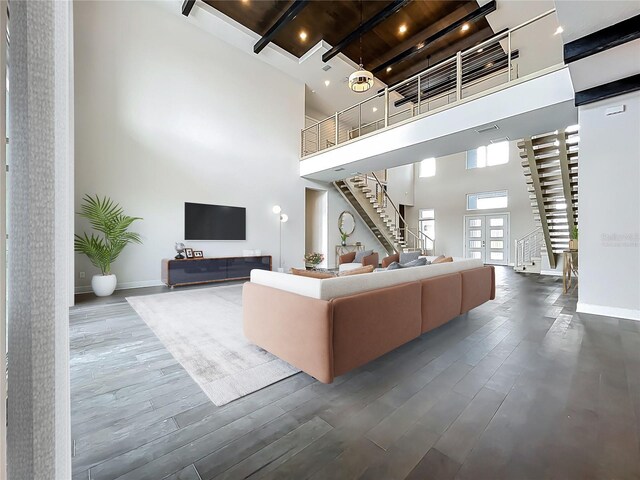 15121 Pendio Dr, Montverde, FL 34756 - living room with a high ceiling, stairway, wood finished floors, and baseboards