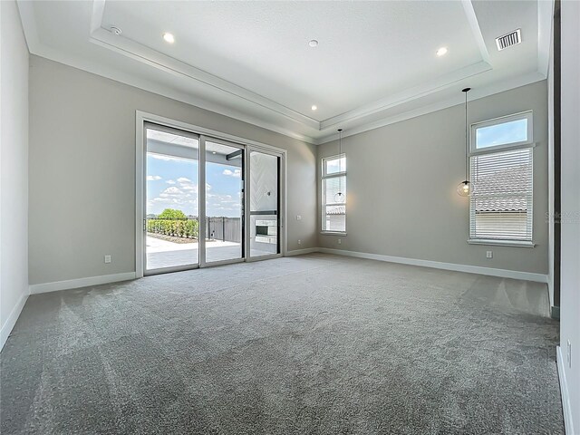 15121 Pendio Dr, Montverde, FL 34756 - carpeted empty room featuring a tray ceiling, baseboards, recessed lighting, and crown molding