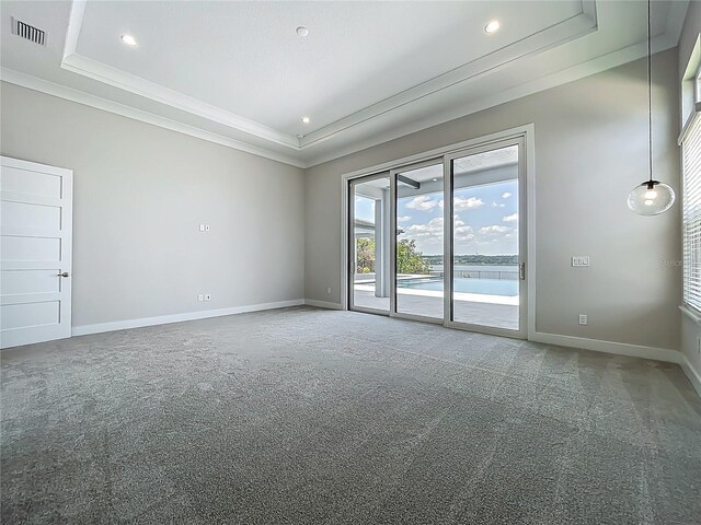 15121 Pendio Dr, Montverde, FL 34756 - empty room featuring a tray ceiling, ornamental molding, baseboards, carpet flooring, and recessed lighting