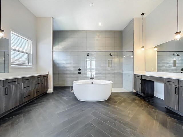 15121 Pendio Dr, Montverde, FL 34756 - bathroom with wood finished floors, vanity, a soaking tub, and a tile shower