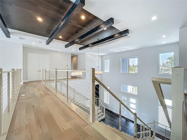 15121 Pendio Dr, Montverde, FL 34756 - hallway featuring an upstairs landing, beam ceiling, light wood-style flooring, and recessed lighting