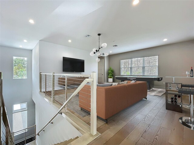 15121 Pendio Dr, Montverde, FL 34756 - living room featuring healthy amount of natural light, wood finished floors, recessed lighting, and baseboards