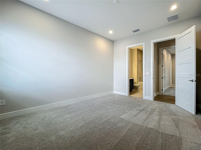 15121 Pendio Dr, Montverde, FL 34756 - unfurnished bedroom featuring baseboards, carpet floors, recessed lighting, and ensuite bath