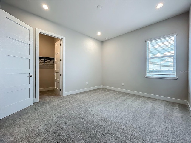 15121 Pendio Dr, Montverde, FL 34756 - unfurnished bedroom featuring carpet, baseboards, a walk in closet, and recessed lighting