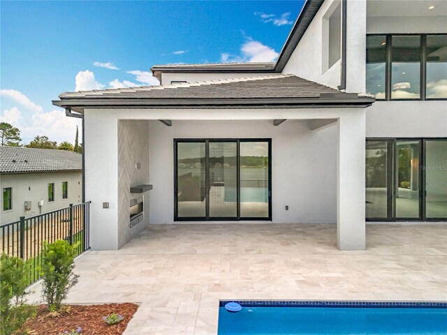 15121 Pendio Dr, Montverde, FL 34756 - back of property featuring stucco siding and a patio