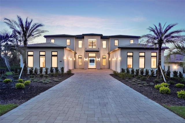 15121 Pendio Dr, Montverde, FL 34756 - view of front of house featuring an attached garage, decorative driveway, and stucco siding