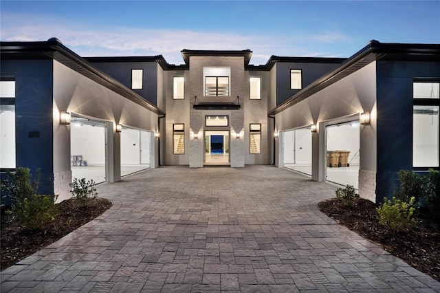 15121 Pendio Dr, Montverde, FL 34756 - view of front of house with an attached garage, decorative driveway, and stucco siding