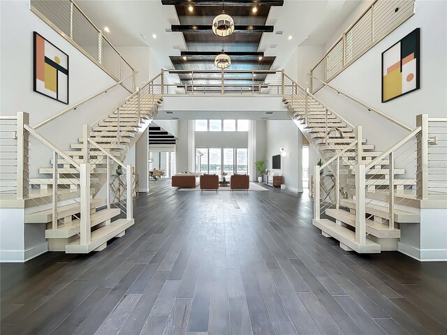 15121 Pendio Dr, Montverde, FL 34756 - stairway featuring a high ceiling, wood finished floors, and baseboards