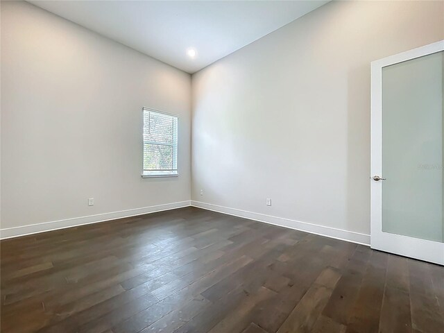 15121 Pendio Dr, Montverde, FL 34756 - empty room with dark wood finished floors and baseboards