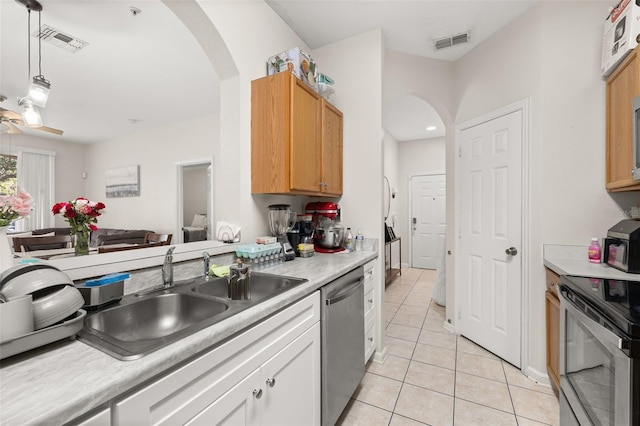 6214 Stevenson Dr Unit 106, Orlando, FL 32835 - kitchen featuring stainless steel appliances, arched walkways, a sink, and light countertops