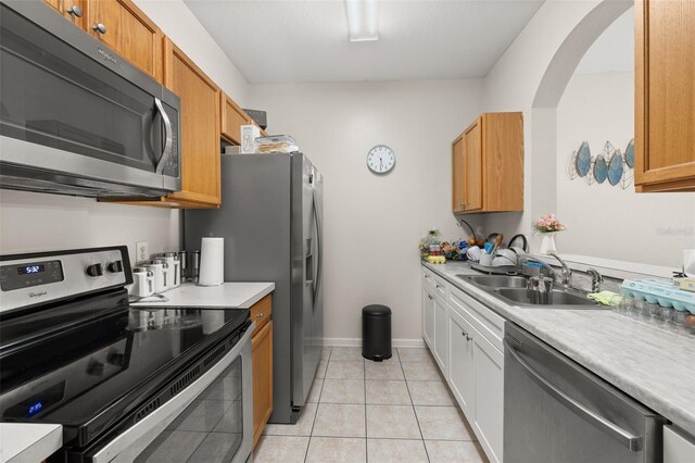 6214 Stevenson Dr Unit 106, Orlando, FL 32835 - kitchen with appliances with stainless steel finishes, a sink, light countertops, and light tile patterned flooring