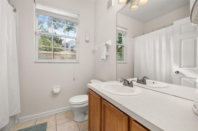 6214 Stevenson Dr Unit 106, Orlando, FL 32835 - bathroom with tile patterned floors, plenty of natural light, vanity, and toilet