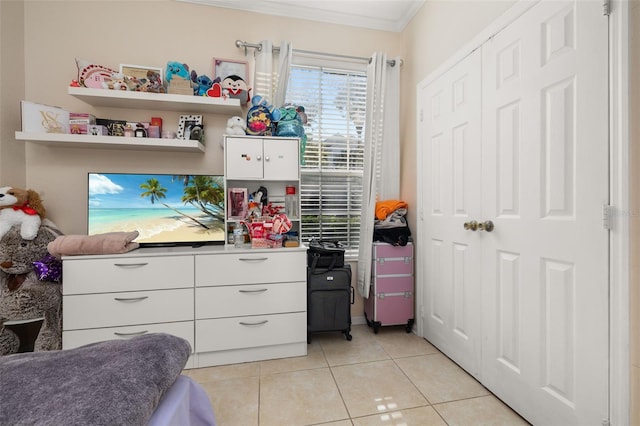 6214 Stevenson Dr Unit 106, Orlando, FL 32835 - bedroom featuring ornamental molding, light tile patterned flooring, and a closet
