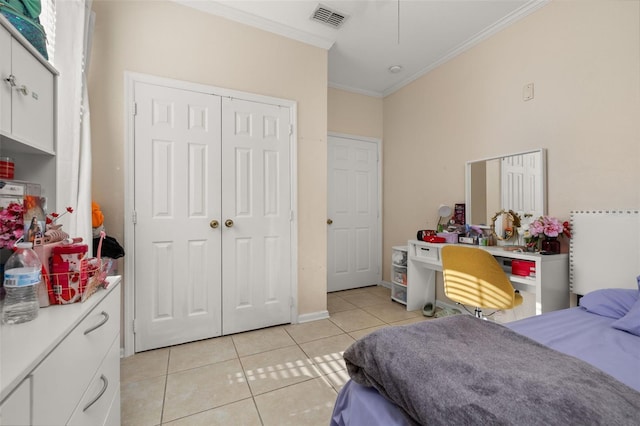 6214 Stevenson Dr Unit 106, Orlando, FL 32835 - bedroom with crown molding, light tile patterned flooring, a closet, and attic access