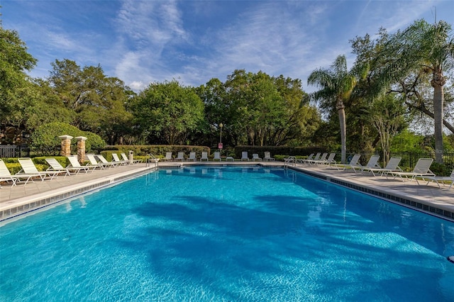 6214 Stevenson Dr Unit 106, Orlando, FL 32835 - community pool with view of scattered trees and a patio