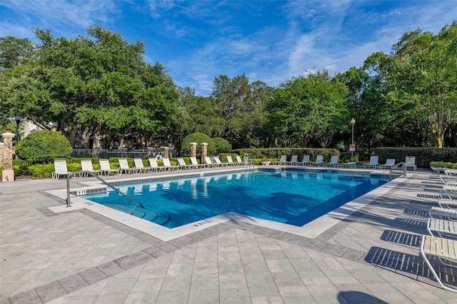 6214 Stevenson Dr Unit 106, Orlando, FL 32835 - community pool featuring a patio and view of wooded area