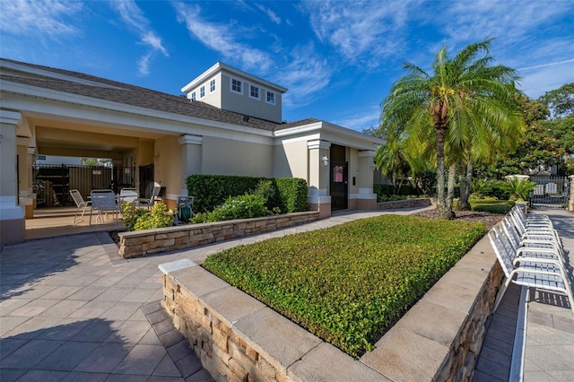 6214 Stevenson Dr Unit 106, Orlando, FL 32835 - exterior space featuring stucco siding and a patio area