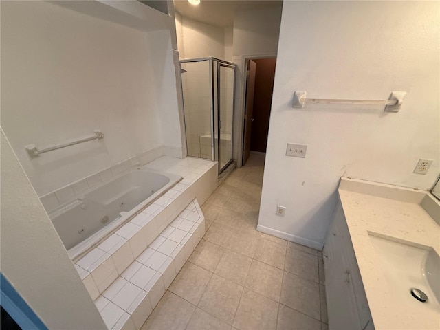 709 Orchid Dr, Davenport, FL 33897 - bathroom with a stall shower, a whirlpool tub, tile patterned flooring, vanity, and baseboards