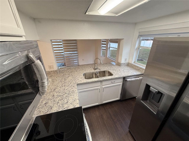 709 Orchid Dr, Davenport, FL 33897 - kitchen with a sink, dishwasher, white cabinets, dark wood finished floors, and light stone countertops