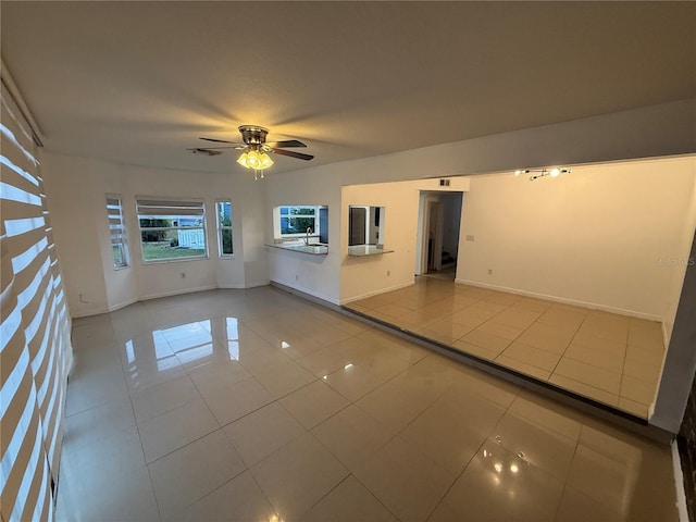 709 Orchid Dr, Davenport, FL 33897 - empty room with tile patterned flooring, a ceiling fan, a sink, and baseboards
