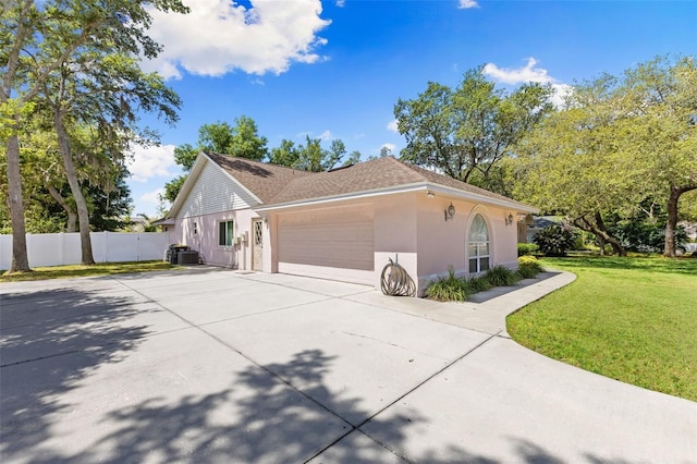 7222 Stanford Dr, Lakeland, FL 33809 - view of home's exterior featuring stucco siding, an attached garage, and concrete driveway