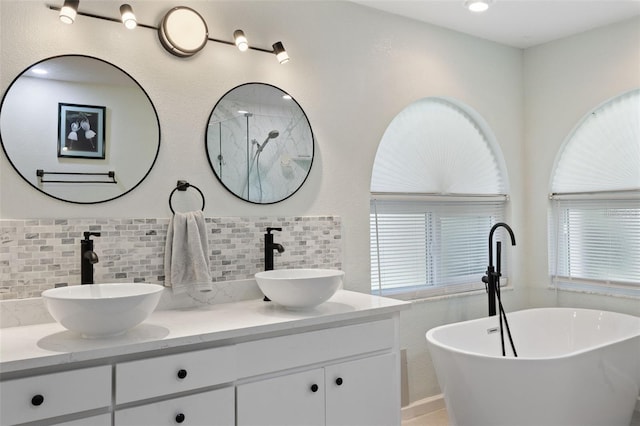 7222 Stanford Dr, Lakeland, FL 33809 - full bath featuring a soaking tub, decorative backsplash, double vanity, and a shower