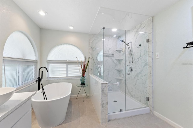 7222 Stanford Dr, Lakeland, FL 33809 - bathroom featuring a marble finish shower, a freestanding bath, baseboards, vanity, and tile patterned flooring
