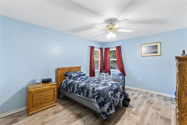 7222 Stanford Dr, Lakeland, FL 33809 - bedroom with baseboards, light wood-style floors, and a ceiling fan