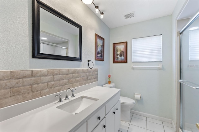 7222 Stanford Dr, Lakeland, FL 33809 - bathroom with vanity, toilet, a shower with door, and tile patterned floors